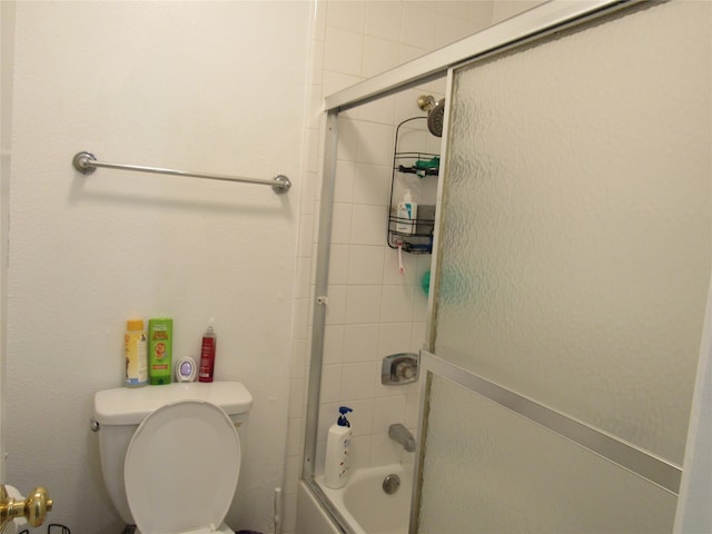 bathroom with toilet and enclosed tub / shower combo