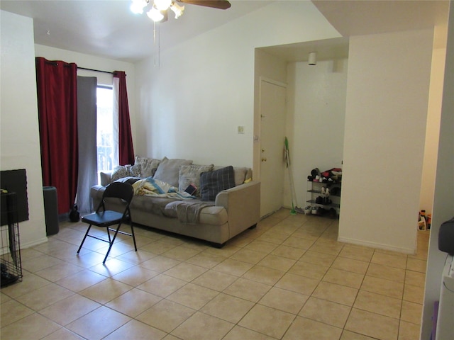 living room with vaulted ceiling, ceiling fan, and light tile flooring