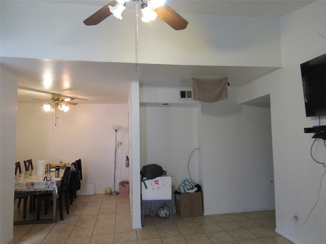 interior space with ceiling fan