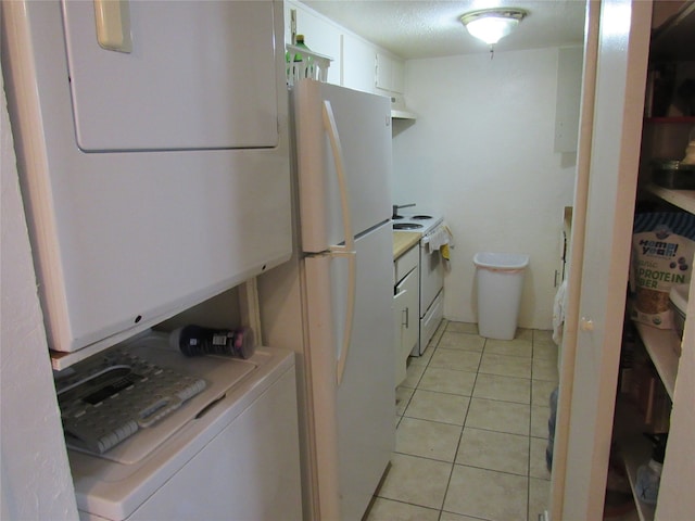 clothes washing area featuring washer / clothes dryer and light tile floors