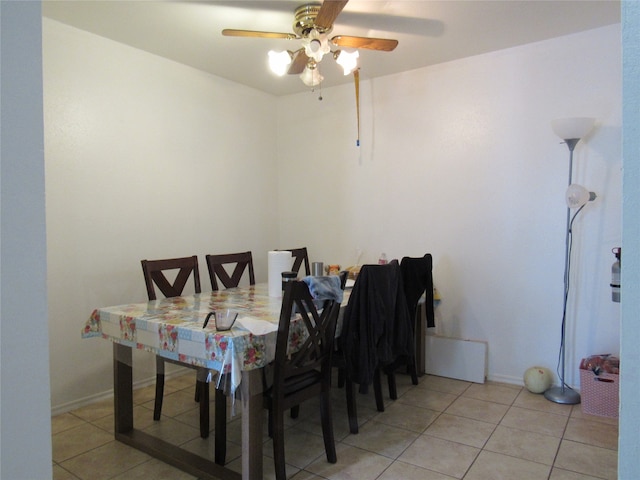 dining space with light tile floors and ceiling fan