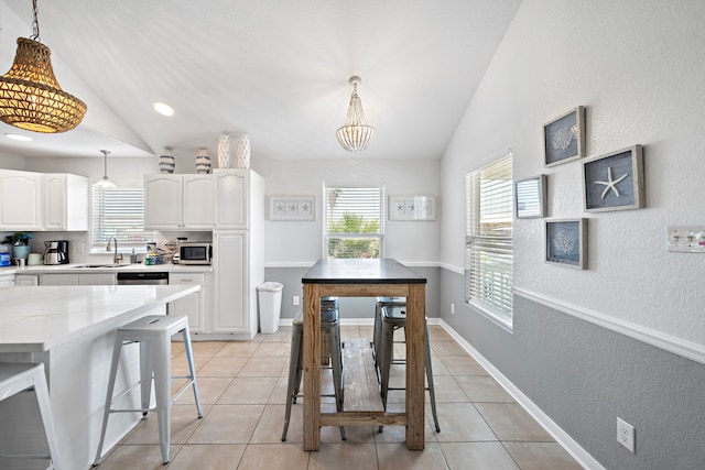 interior space with an inviting chandelier, lofted ceiling, and sink