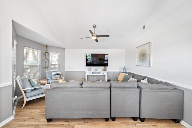 living room with light hardwood / wood-style floors, ceiling fan, and lofted ceiling