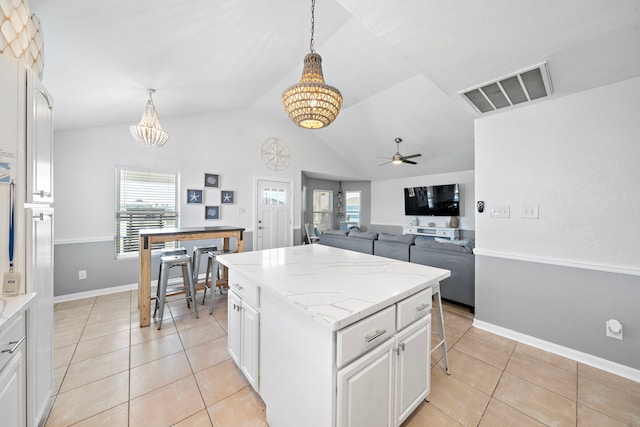 kitchen with light tile flooring, pendant lighting, vaulted ceiling, and ceiling fan with notable chandelier