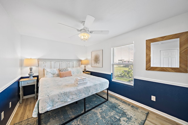 bedroom featuring ceiling fan and hardwood / wood-style flooring