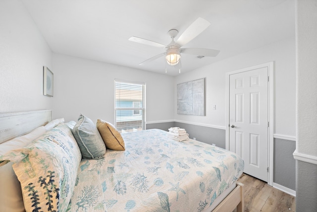 bedroom featuring light hardwood / wood-style floors and ceiling fan