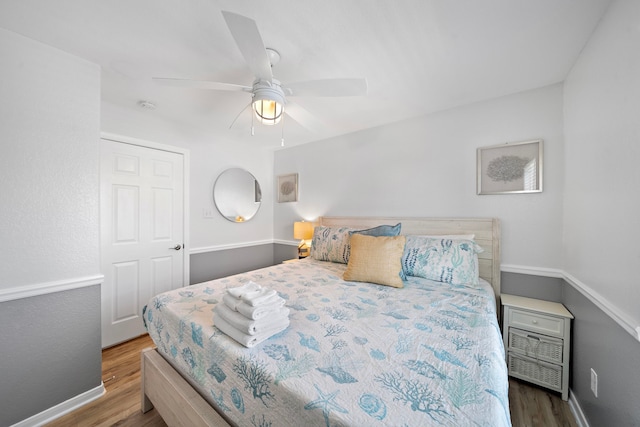 bedroom featuring dark hardwood / wood-style flooring and ceiling fan