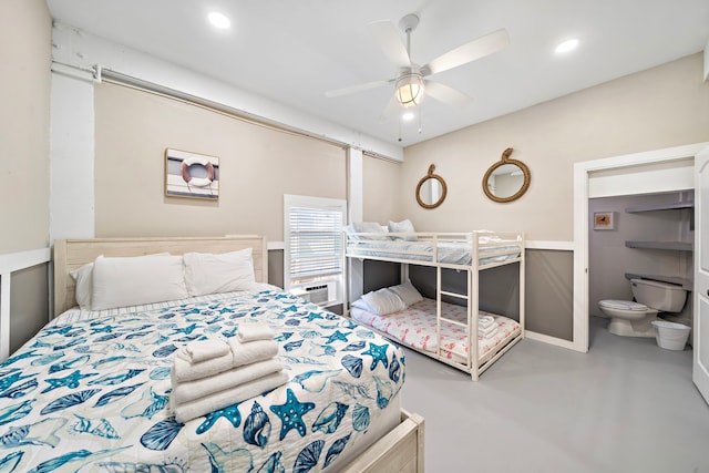 bedroom with concrete floors, ceiling fan, and ensuite bathroom