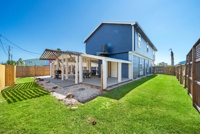 rear view of property featuring central AC, a yard, and a patio area