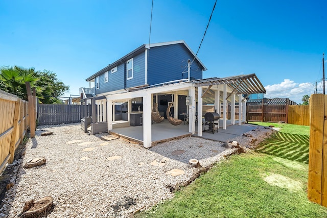 back of house with a yard, a pergola, and a patio