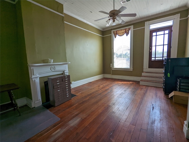 unfurnished living room with ceiling fan, crown molding, and dark hardwood / wood-style floors