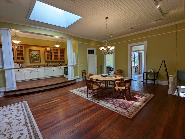 20 E Robert Toombs, Washington, GA 30673 - dining room featuring rail lighting, dark wood finished floors, decorative columns, and a chandelier