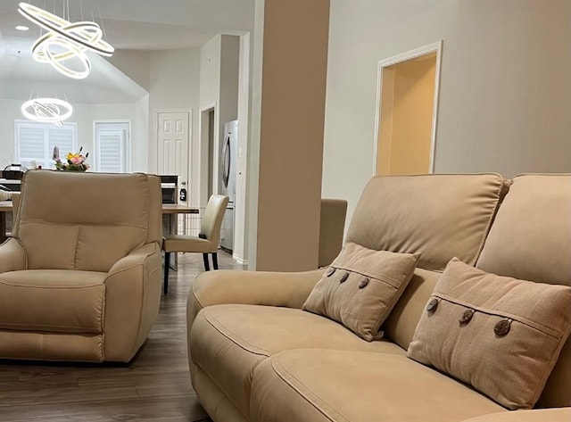 living room with dark hardwood / wood-style floors and a chandelier