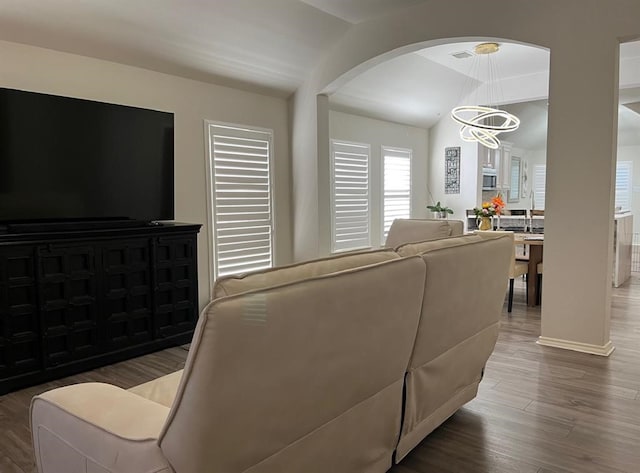 living room with dark hardwood / wood-style floors and a chandelier