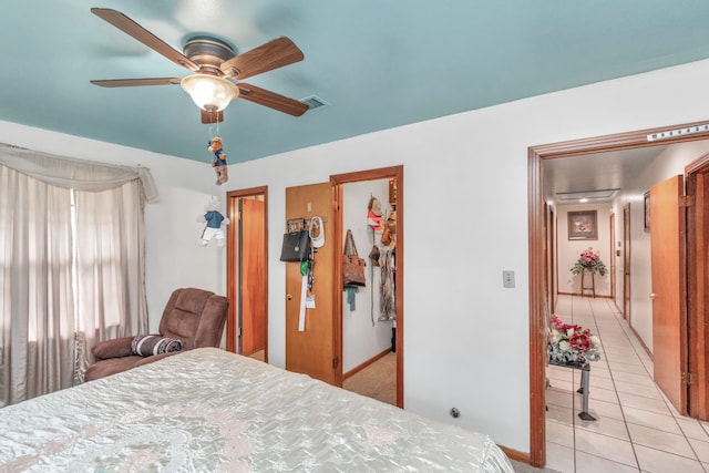 tiled bedroom featuring ceiling fan