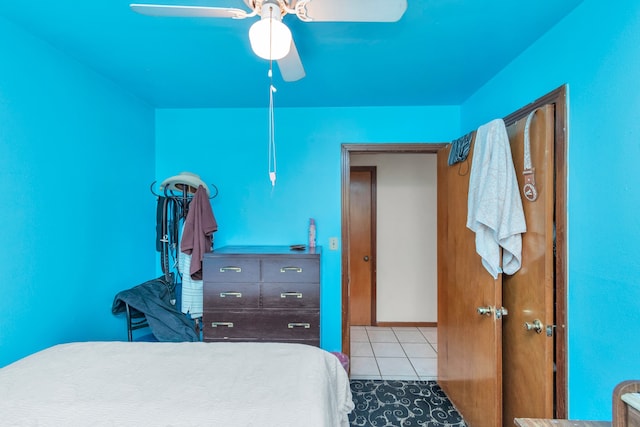 tiled bedroom featuring ceiling fan