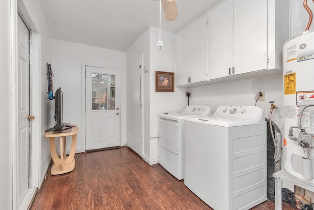 clothes washing area with ceiling fan, washer and clothes dryer, dark wood-type flooring, water heater, and cabinets