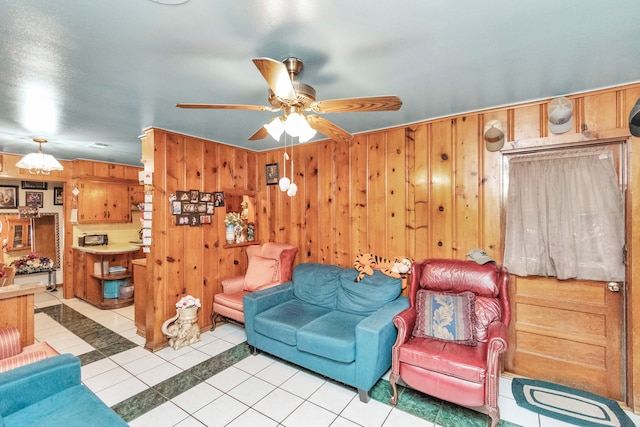 living room with light tile flooring, wooden walls, and ceiling fan