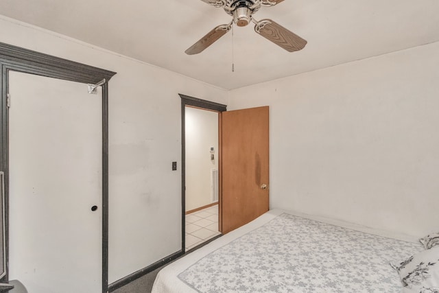 tiled bedroom with ceiling fan