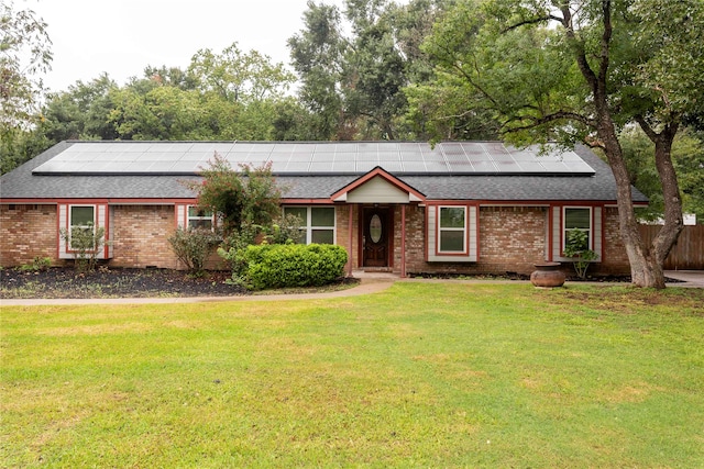 single story home with a front lawn and solar panels