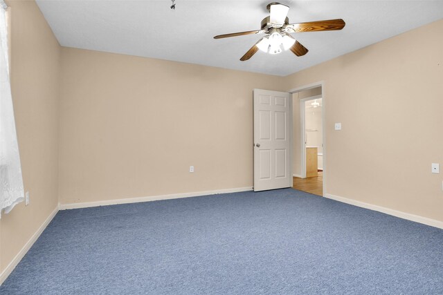 empty room with ceiling fan and light colored carpet