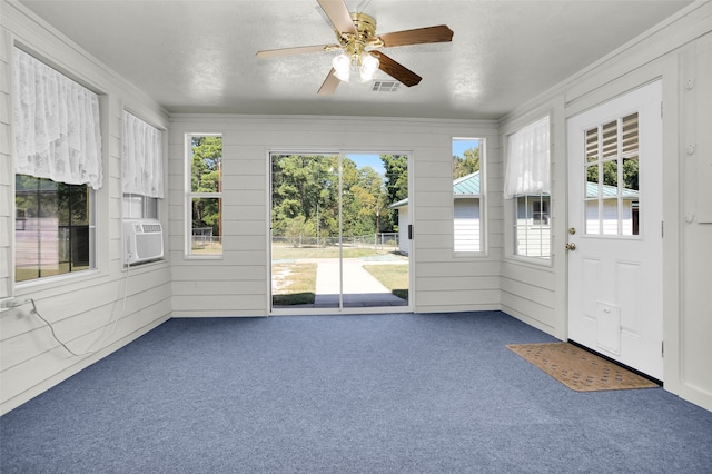 unfurnished sunroom featuring cooling unit and ceiling fan