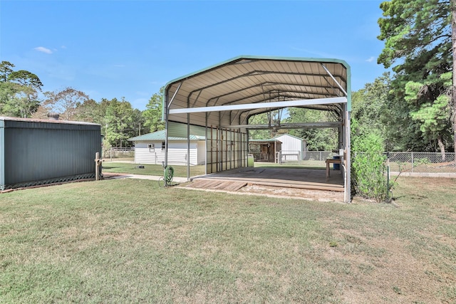 351 Trinity Dr, Trinity, TX 75862 - view of yard with a storage shed, a detached carport, fence, and an outbuilding