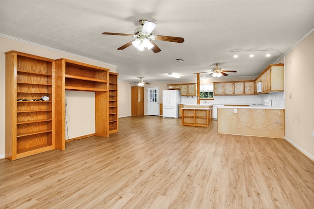 unfurnished living room featuring light wood-type flooring, ceiling fan, track lighting, sink, and ornamental molding