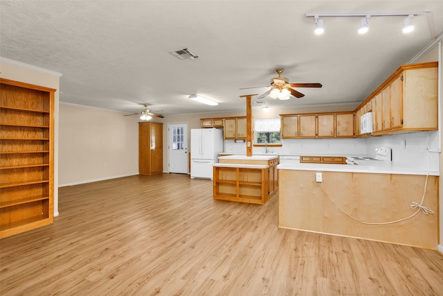 kitchen with ceiling fan, white appliances, light hardwood / wood-style floors, a textured ceiling, and kitchen peninsula