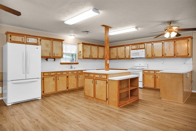 kitchen featuring a center island, ceiling fan, white appliances, and light hardwood / wood-style floors