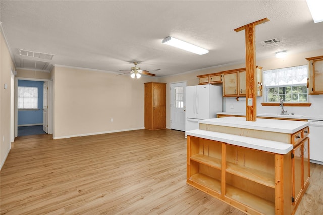 351 Trinity Dr, Trinity, TX 75862 - kitchen with visible vents, a center island, open shelves, a sink, and white appliances