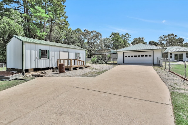 manufactured / mobile home featuring a garage and an outbuilding