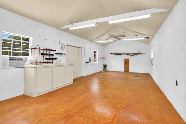 interior space with lofted ceiling with beams, cooling unit, ceiling fan, and light hardwood / wood-style floors