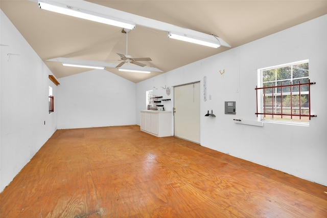 interior space with ceiling fan, vaulted ceiling, and electric panel