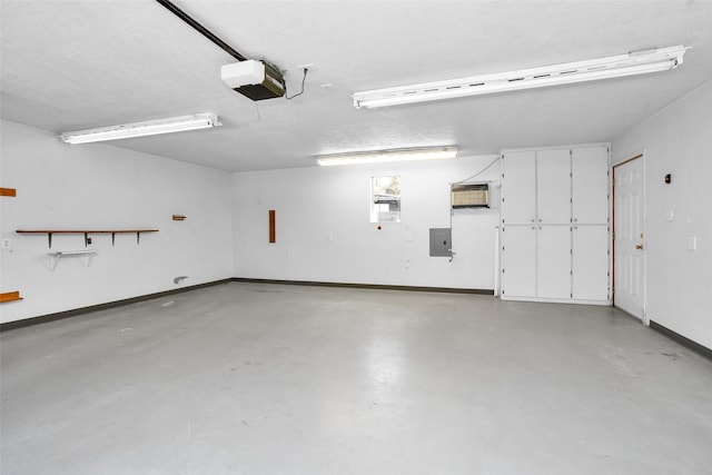 351 Trinity Dr, Trinity, TX 75862 - garage featuring baseboards, a garage door opener, and electric panel