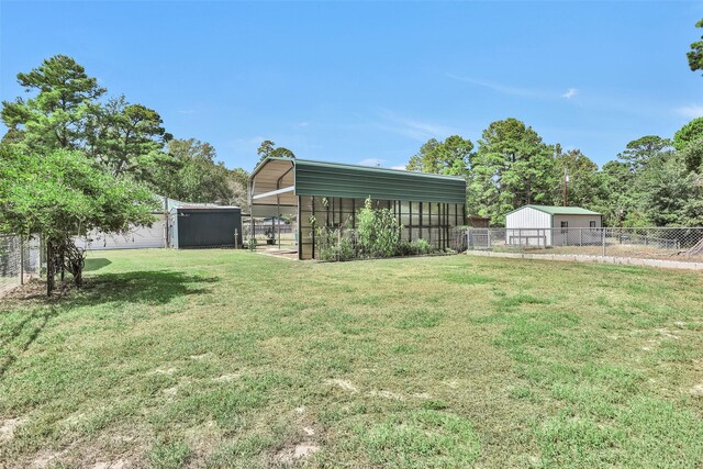 351 Trinity Dr, Trinity, TX 75862 - view of yard featuring fence, an outbuilding, and a detached carport