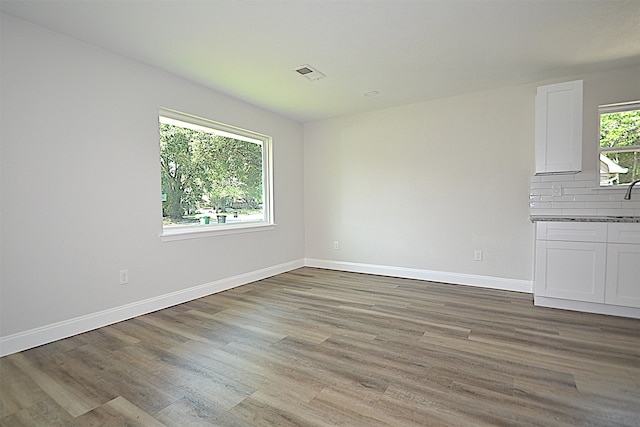 unfurnished living room with wood-type flooring