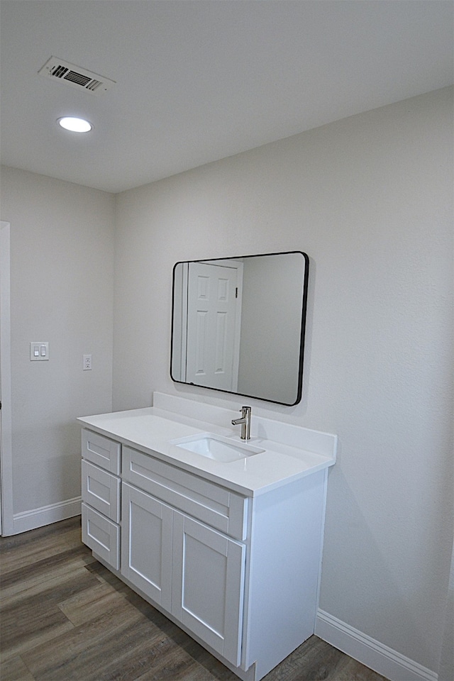 bathroom featuring vanity and hardwood / wood-style floors