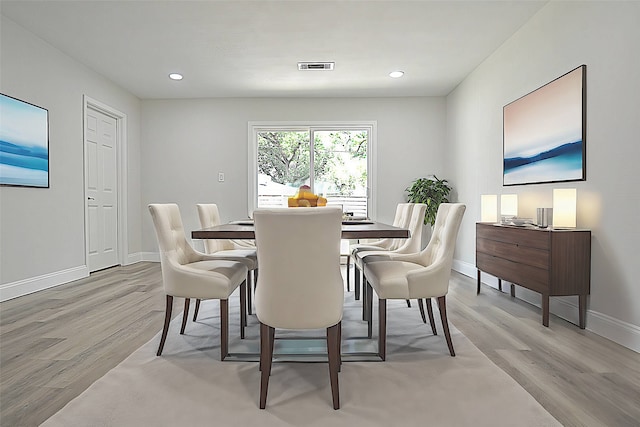 dining space with light hardwood / wood-style floors