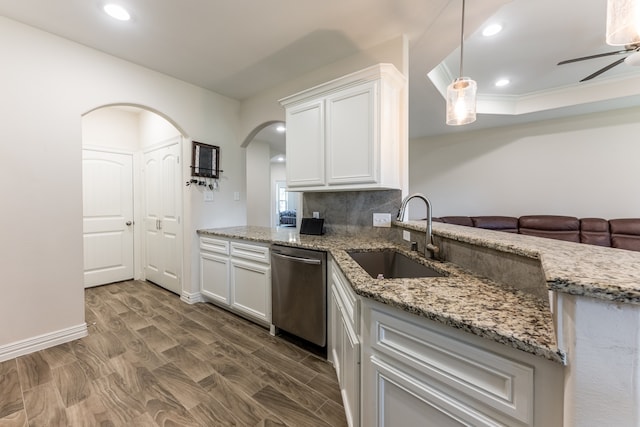 kitchen featuring decorative light fixtures, white cabinetry, stainless steel dishwasher, ceiling fan, and sink