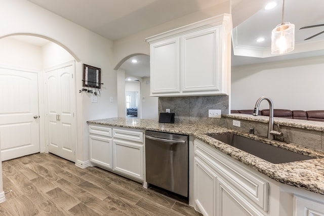 kitchen with white cabinetry, backsplash, sink, light hardwood / wood-style flooring, and dishwasher