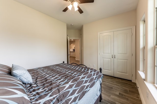 bedroom with a closet, ceiling fan, and dark hardwood / wood-style floors