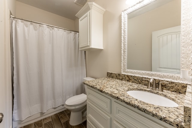 bathroom with wood-type flooring, toilet, and vanity