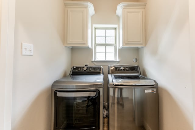 laundry room featuring cabinets and separate washer and dryer