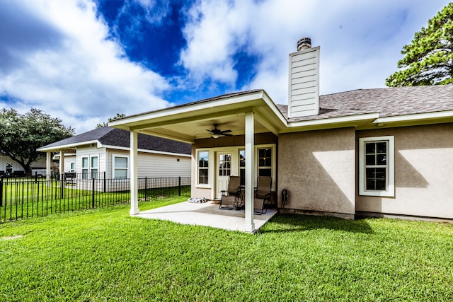 back of house with a lawn, a patio, and ceiling fan