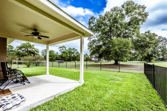 view of yard with ceiling fan and a patio