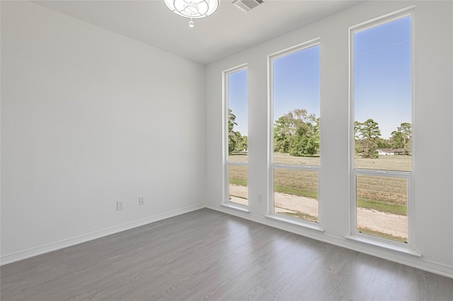 empty room with dark hardwood / wood-style flooring