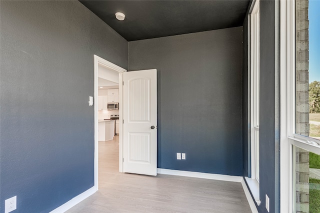 unfurnished room featuring light hardwood / wood-style floors