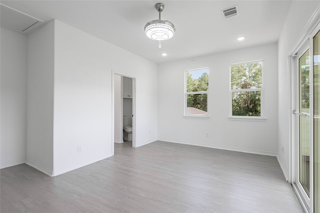 spare room with light hardwood / wood-style flooring