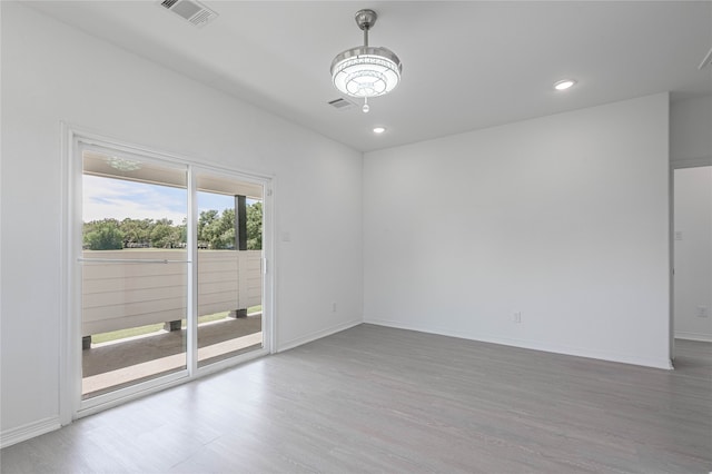 spare room featuring light hardwood / wood-style floors